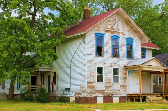 Vacant, weathered house with peeling paint