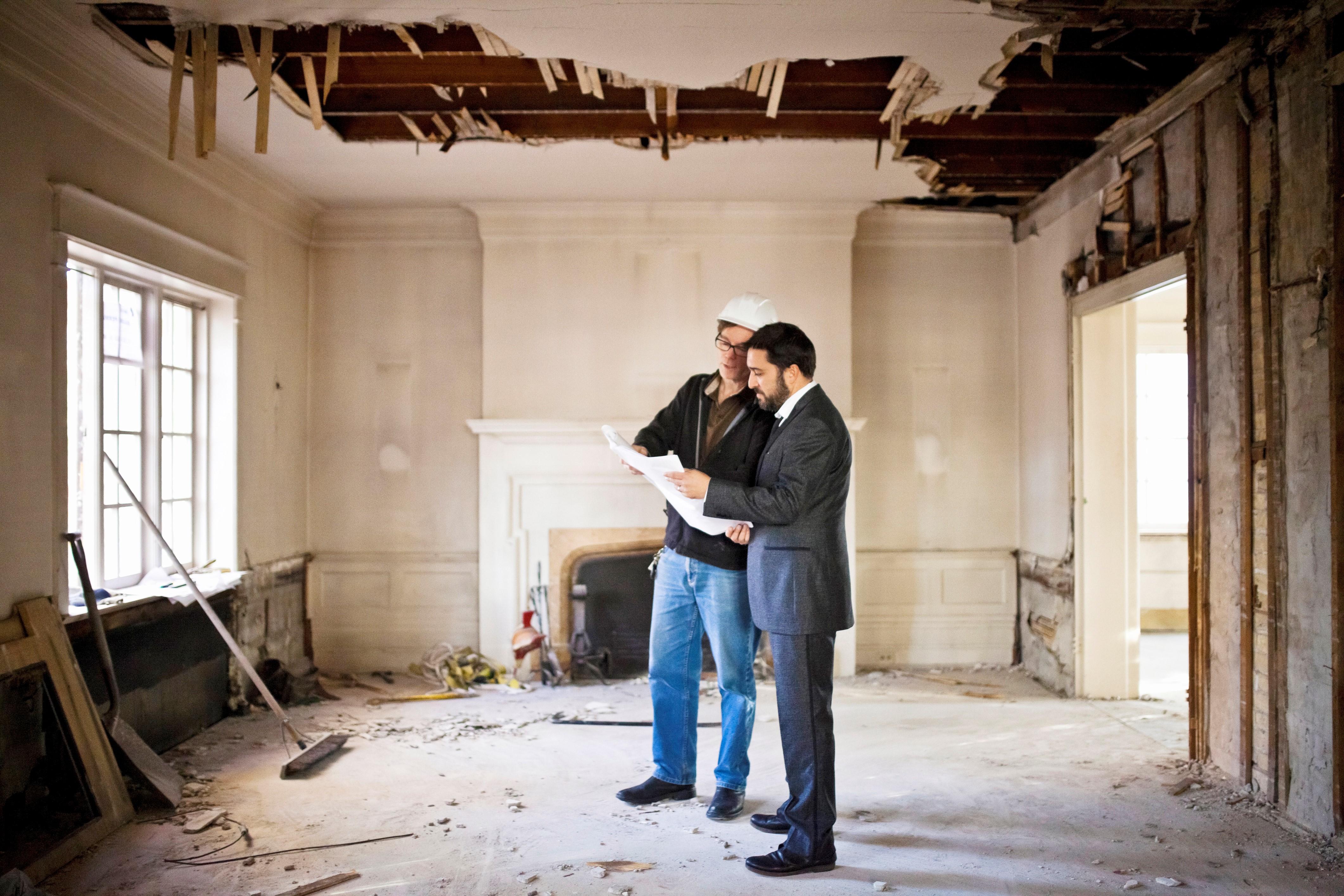 Construction crew renovating a home interior in sunlight